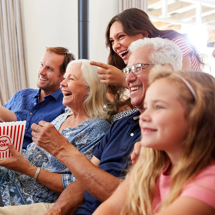 Multigenerational family enjoying a movie together at home